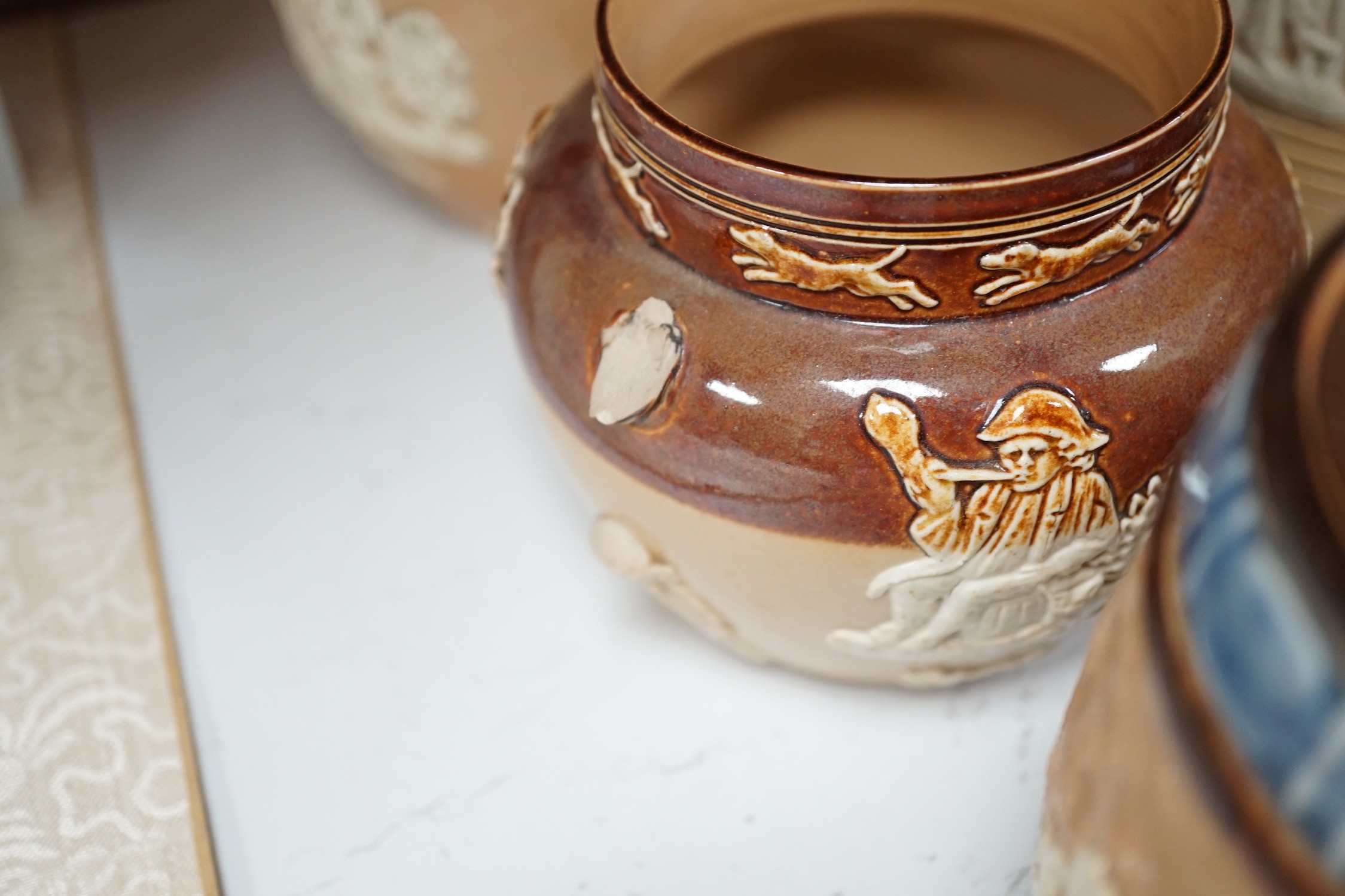 A quantity of Doulton stoneware tobacco jars and jugs